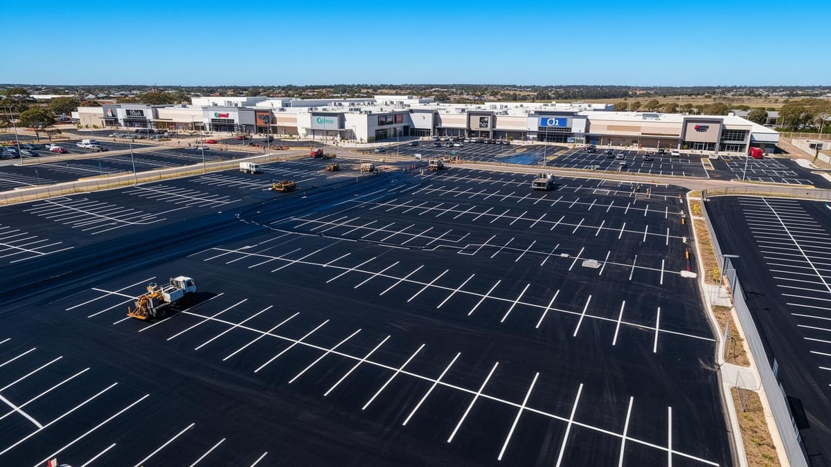 Aerial view of a large commercial car park being maintained and resealed